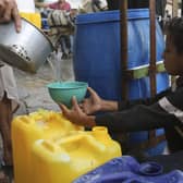 A Palestinian boy fills a cup with drinking water during the ongoing Israeli bombardment of the Gaza Strip in Rafah at the weekend