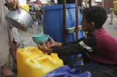 A Palestinian boy fills a cup with drinking water during the ongoing Israeli bombardment of the Gaza Strip in Rafah at the weekend