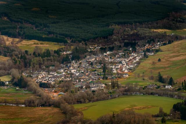 View of the village of Killin in Scotland at dusk from the Tarmachan ridge. Copyright (c) 2018 cornfield/Shutterstock.