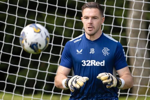Jack Butland keeps his eye on the ball during Rangers training.