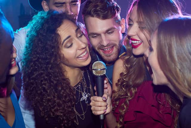 Here's how to try out Spotify Karaoke for yourself. Photo: mediaphotos / Getty Images / Canva Pro.
