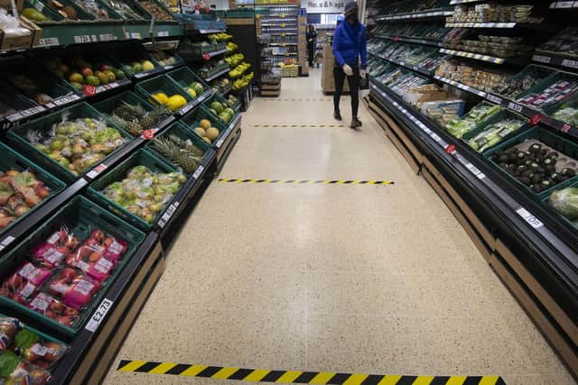 Social distancing markers on the floor of a supermarket.