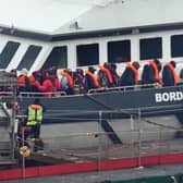 A group of people thought to be migrants are brought in to Dover, Kent, following a small boat incident in the Channel at the weekend.  Pic: PA Wire