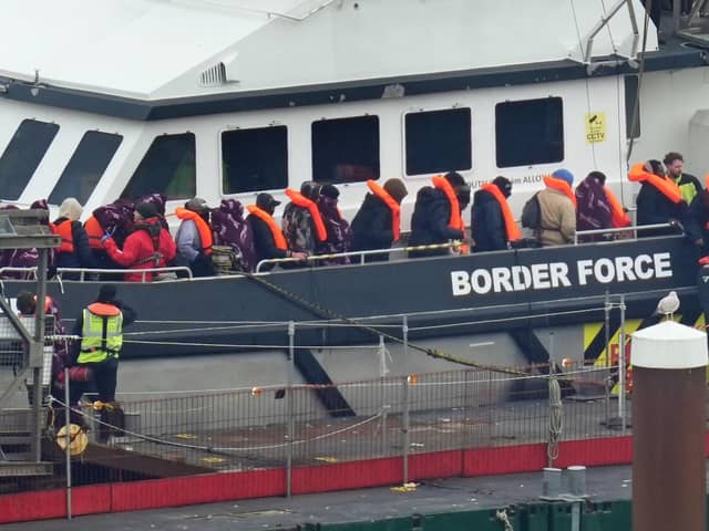 A group of people thought to be migrants are brought in to Dover, Kent, following a small boat incident in the Channel at the weekend.  Pic: PA Wire