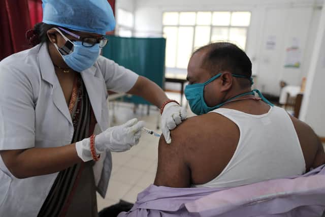 A health worker inoculates a man with Covid vaccine in Prayagraj, India (Picture: Rajesh Kumar Singh/AP)