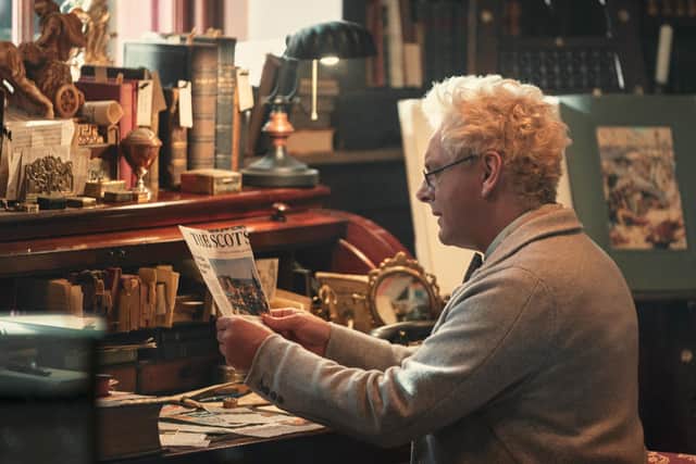 While investigating a mystery, Michael Sheen's Good Omens character Aziraphale can be seen reading an article from The Scotsman.