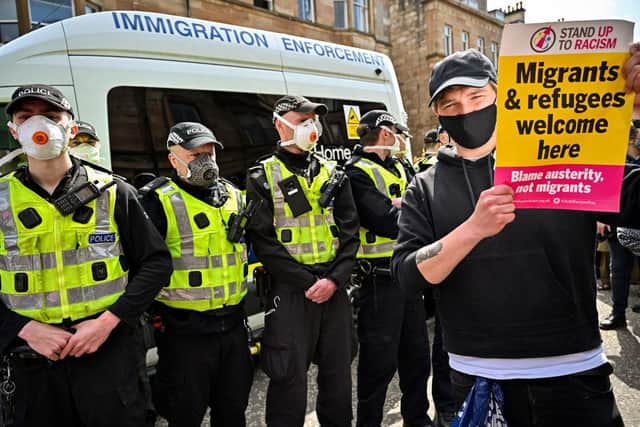 Protestors block an immigration enforcement van, stopping it from leaving Glasgow's Kenmure Street in Nicola Sturgeon's constituency in May 2021 (Picture: Jeff J Mitchell/Getty Images)