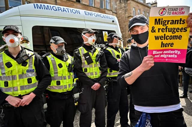 Protestors block an immigration enforcement van, stopping it from leaving Glasgow's Kenmure Street in Nicola Sturgeon's constituency in May 2021. Picture: Jeff J Mitchell/Getty Images