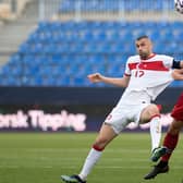 Turkey's forward Burak Yilmaz (L) heads the ball with Norway's defender Kristoffer Ajer during the FIFA World Cup Qatar 2022 qualification football match between Norway and Turkey at La Rosaleda stadium in Malaga on March 27, 2021. (Photo by JORGE GUERRERO/AFP via Getty Images)