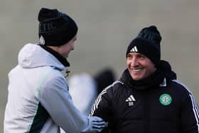 Brendan Rodgers shares a smile with David Turnbull during a Celtic training session.