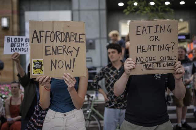 Protesters hold placards during a demonstration against rising energy prices outside Ofgem's headquarters in Canary Wharf. Picture: Rob Pinney/Getty Images