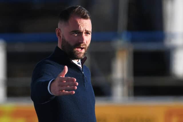 James McPake saw his Dundee side secure second spot in the Championship with a 2-0 win over Queen of the South