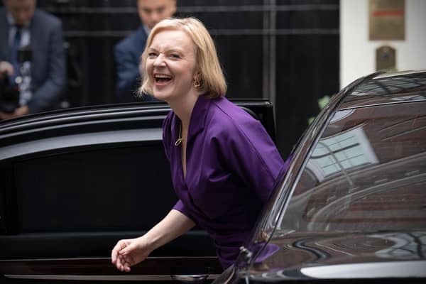 Liz Truss laughs at a funny joke she's just invented as she arrives at Conservative headquarters on the day she was elected party leader (Picture: Carl Court/Getty Images)