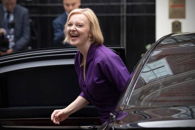 Liz Truss laughs at a funny joke she's just invented as she arrives at Conservative headquarters on the day she was elected party leader (Picture: Carl Court/Getty Images)