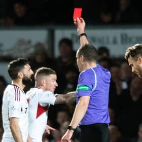 Aberdeen captain Graeme Shinnie is shown a red card for his challenge on Ross County's Jack Baldwin following a VAR check.  (Photo by Mark Scates / SNS Group)