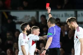 Aberdeen captain Graeme Shinnie is shown a red card for his challenge on Ross County's Jack Baldwin following a VAR check.  (Photo by Mark Scates / SNS Group)