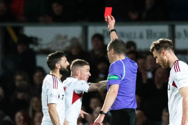 Aberdeen captain Graeme Shinnie is shown a red card for his challenge on Ross County's Jack Baldwin following a VAR check.  (Photo by Mark Scates / SNS Group)