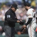 San Francisco Giants pitcher Jose Alvarez, right, has his cap inspected by umpire Alfonso Marquez. Picture: Jeff Chiu/AP