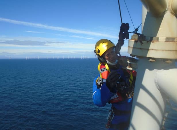 A PD&MS rope access technician working at a wind farm off the coast of Scotland.