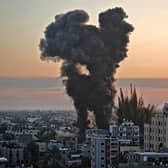TOPSHOT - Black smoke billows after a series of Israeli airstrikes targeted Khan Yunis in the southern Gaza strip, early on May 12, 2021. - Israeli air raids in the Gaza Strip have hit the homes of high-ranking members of the Hamas militant group, the military said Wednesday, with the territory's police headquarters also targeted. (Photo by YOUSSEF MASSOUD / AFP) (Photo by YOUSSEF MASSOUD/AFP via Getty Images)