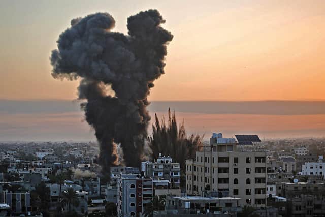 TOPSHOT - Black smoke billows after a series of Israeli airstrikes targeted Khan Yunis in the southern Gaza strip, early on May 12, 2021. - Israeli air raids in the Gaza Strip have hit the homes of high-ranking members of the Hamas militant group, the military said Wednesday, with the territory's police headquarters also targeted. (Photo by YOUSSEF MASSOUD / AFP) (Photo by YOUSSEF MASSOUD/AFP via Getty Images)