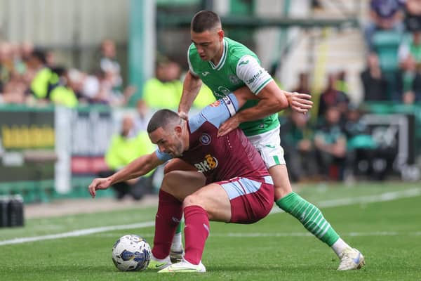 Aston Villa's John McGinn holds off the challenge of Hibs full-back Lewis Miller.  (Photo by Craig Williamson / SNS Group)