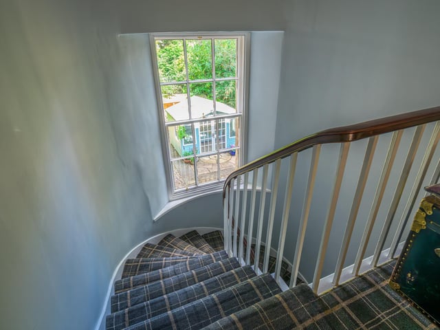 The impressive staircase at the heart of the property