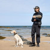 Erland Cooper at North Berwick beach with his dog Mirage, the Bass Rock in the background