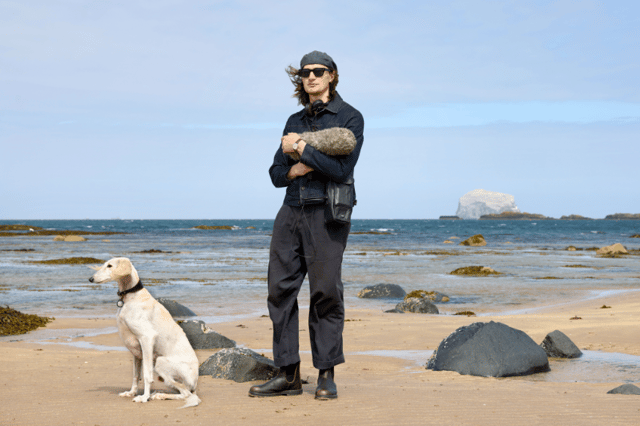 Erland Cooper at North Berwick beach with his dog Mirage, the Bass Rock in the background