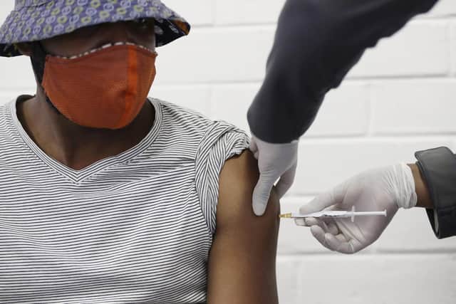 A volunteer at the Chris Hani Baragwanath hospital in Soweto, South Africa, receives a Oxford/AstraZeneca test vaccine during trials in June year. However, supplies of the vaccine have been limited in Africa and other parts of the developing world (Picture: Siphiwe Sibeko/AP)
