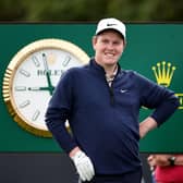 A smiling Bob MacIntyre waits on the fifth tee with caddie Greg Milne during a practice round prior to The 151st Open at Royal Liverpool. Picture: Jared C. Tilton/Getty Images.