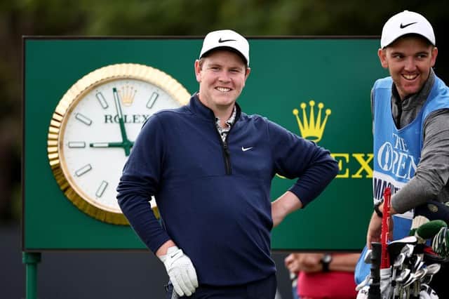 A smiling Bob MacIntyre waits on the fifth tee with caddie Greg Milne during a practice round prior to The 151st Open at Royal Liverpool. Picture: Jared C. Tilton/Getty Images.