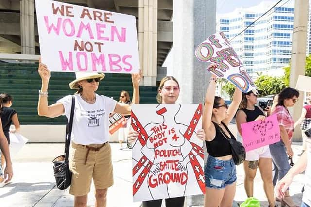 An abortion rights activist holds a sign at a protest in support of abortion access, March To Roe The Vote And Send A Message To Florida Politicians That Abortion Access Must Be Protected And Defended, on July 13, 2022 in Fort Lauderdale, Florida. (Photo by John Parra/Getty Images for MoveOn)