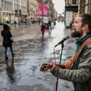 Glasgow commuters walk along Buchanan Street.