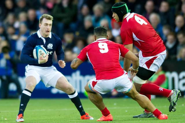 Scotland's Stuart Hogg takes on Tonga's Sonatane Takulua (9) and Tukulua Lokotui the last time the sides met, in Kilmarnock in 2014. Picture: Jane Barlow/SNS