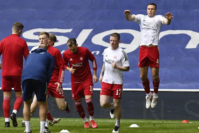 Aberdeen's Andy Considine (right) warms up  during the Scottish Premiership match  between Rangers and Aberdeen  at Ibrox Stadium, on May 15, 2021, in Glasgow, Scotland. (Photo by Rob Casey / SNS Group)