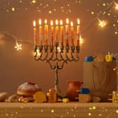 The Menorah holds nine candles, eight of which are lit using the ninth throughout the festival. Photo: tomertu / Getty Images /Canva Pro