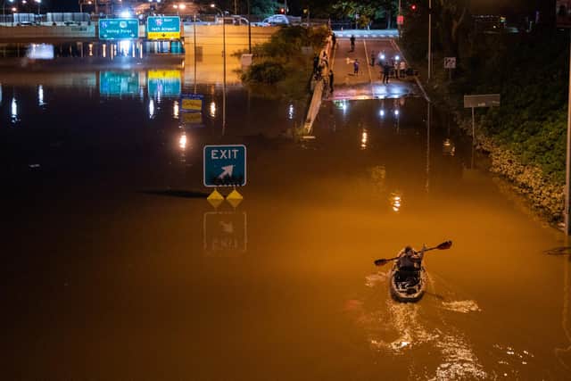 A kayaker paddles along Interstate 676 in Philadelphia after flash floods hit the area in the aftermath of Hurricane Ida (Picture: Branden Eastwood/AFP via Getty Images)
