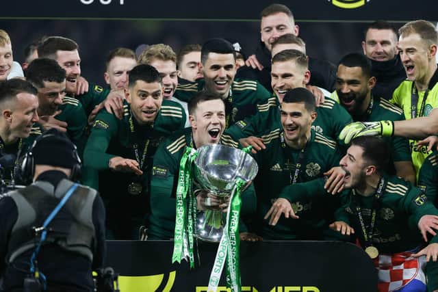 Celtic captain Callum McGregor lifts the Premier Sports Cup.
