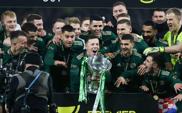 Celtic captain Callum McGregor lifts the Premier Sports Cup.