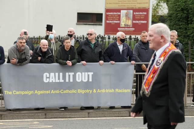 A silent Orange Order band walks passes by a Call It Out protest outside St Benedict's church in Easterhouse, Glasgow. Picture date: Saturday September 18, 2021. PA Photo. Photo credit should read: Robert Perry/PA Wire