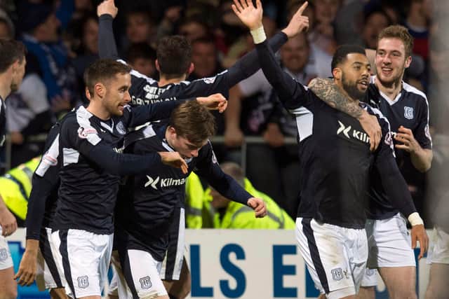 Craig Wighton is mobbed by Dundee teammates after scoring the goal that relegated Dundee United in 2016.