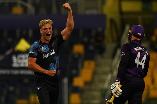 Namibia's Ruben Trumpelmann celebrates after the dismissal of Scotland's Richie Berrington. (Photo by INDRANIL MUKHERJEE/AFP via Getty Images)