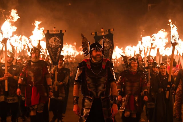 Members of the Up Helly Aa 'Jarl Squad', carrying flaming torches, parade through the streets of Lerwick in the Shetland Islands. Picture: Andy Buchanan/AFP via Getty Images
