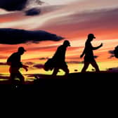 Players in the 51 group cross the Swilcan Bridge in low light as play continues during day one of The Open at the Old Course, St Andrews. Picture: Jane Barlow/PA Wire
