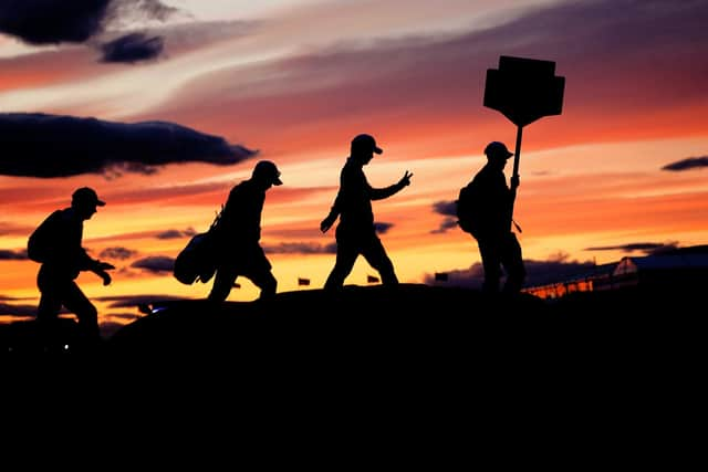 Players in the 51 group cross the Swilcan Bridge in low light as play continues during day one of The Open at the Old Course, St Andrews. Picture: Jane Barlow/PA Wire