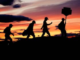 Players in the 51 group cross the Swilcan Bridge in low light as play continues during day one of The Open at the Old Course, St Andrews. Picture: Jane Barlow/PA Wire