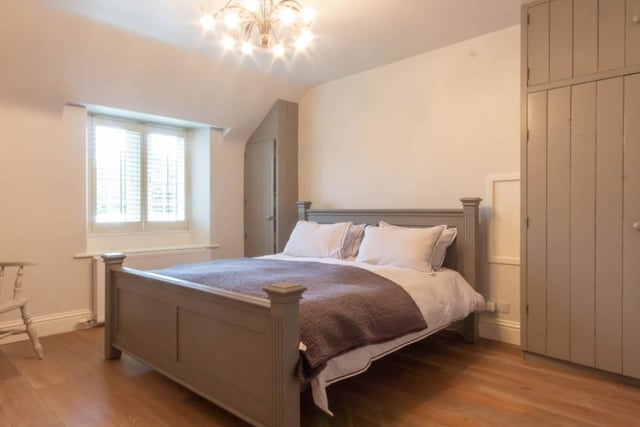 A large double bedroom overlooking the front elevation, which has built in storage and solid oak wood flooring.