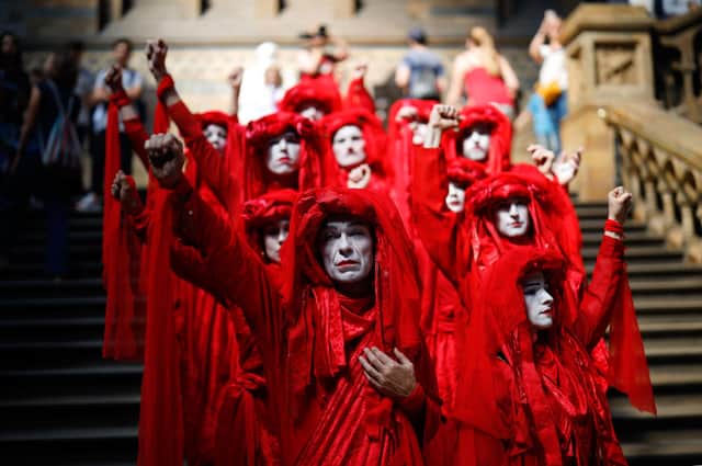 Extinction Rebellion activists in trademark red costumes stage a peaceful protest against climate change (Picture: Tolga Akmen/AFP via Getty Images)
