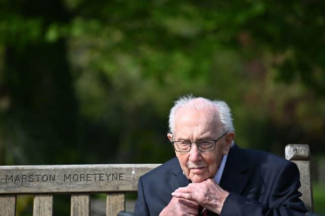 Captain Tom Moore does up his tie as he sits on a bench in the village of Marston Moretaine (Photo: JUSTIN TALLIS/AFP via Getty Images)